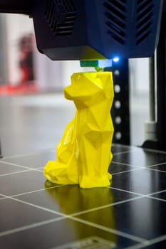Abstract object printing on 3D printer with molten plastic close-up. 3D printer printing model melted plastic. 3D design. 3D Prototyping. New modern printing technology. Additive printer technology.