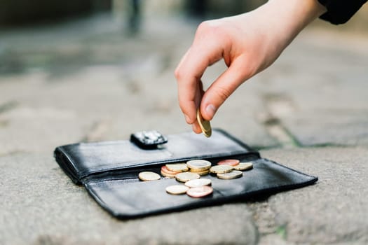 The wallet with coins on a sidewalk street, forgotten money