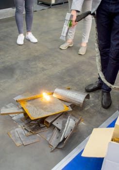 Laser metal cleaning. A man using laser metal cleaning machine to clean a metal surface from rust. Worker cleaning metal from coating by laser. Steel laser clean technologies. New modern technology