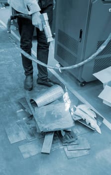 Laser metal cleaning. A man using laser metal cleaning machine to clean a metal surface from rust. Worker cleaning metal from coating by laser. Steel laser clean technologies. New modern technology