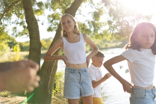 Kids playing outdoors near a sunlit lake in summer
