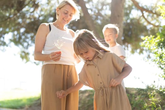 Family exploring outdoors on a sunny day in a park