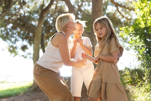 Family spending quality time outdoors in a sunlit park setting