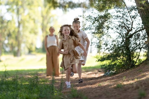 Kids enjoying a playful run along a wooded trail on a sunny day