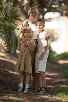 Smiling grandmother enjoying time with grandchildren outdoors