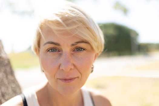 Woman with short hair enjoying a sunny day outside