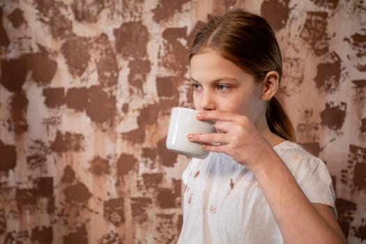A young girl quietly sipping from a beautiful cup, expressing tranquility and warmth in a cozy and intimate setting