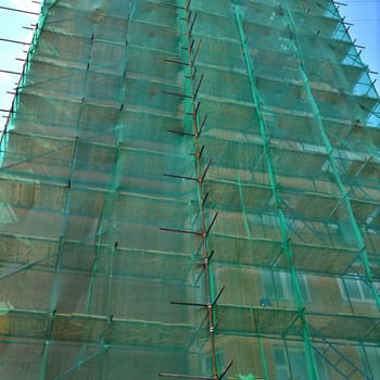 Multi-storey residential building with a scaffolding and safety net