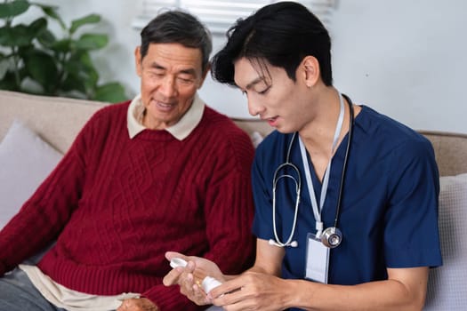 A caring nurse in scrubs provides guidance to an elderly man, explaining medication instructions in a warm and inviting home setting.