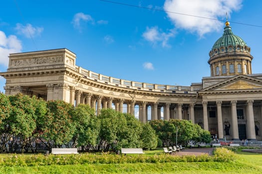 Kazan cathedral's grand colonnade framing historic city square, sunlight illuminating neoclassical architectural splendor in saint petersburg