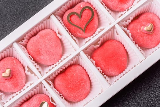 Delicious sweet mochi in the shape of red hearts for the holiday of Valentine's Day