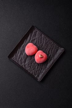 Delicious sweet mochi in the shape of red hearts for the holiday of Valentine's Day