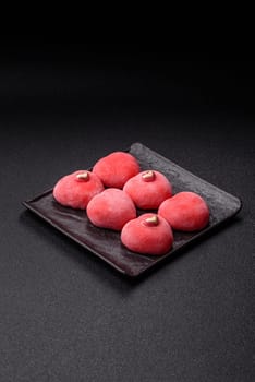 Delicious sweet mochi in the shape of red hearts for the holiday of Valentine's Day