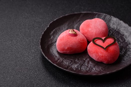 Delicious sweet mochi in the shape of red hearts for the holiday of Valentine's Day