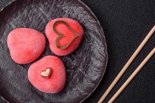 Delicious sweet mochi in the shape of red hearts for the holiday of Valentine's Day