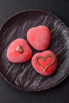 Delicious sweet mochi in the shape of red hearts for the holiday of Valentine's Day