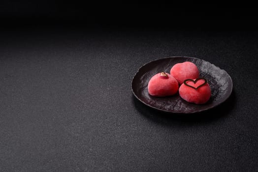 Delicious sweet mochi in the shape of red hearts for the holiday of Valentine's Day