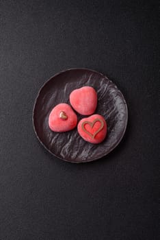 Delicious sweet mochi in the shape of red hearts for the holiday of Valentine's Day