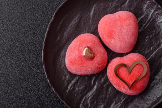 Delicious sweet mochi in the shape of red hearts for the holiday of Valentine's Day