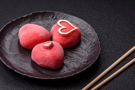 Delicious sweet mochi in the shape of red hearts for the holiday of Valentine's Day