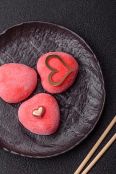 Delicious sweet mochi in the shape of red hearts for the holiday of Valentine's Day