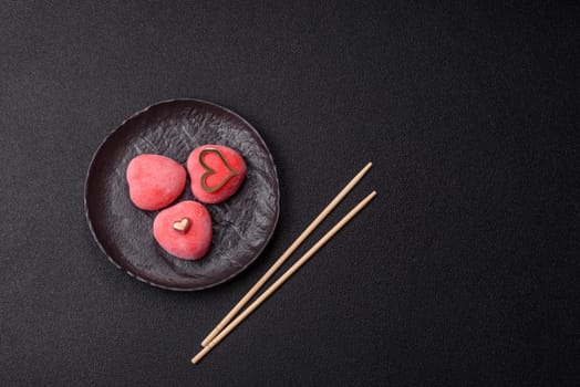 Delicious sweet mochi in the shape of red hearts for the holiday of Valentine's Day