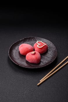 Delicious sweet mochi in the shape of red hearts for the holiday of Valentine's Day