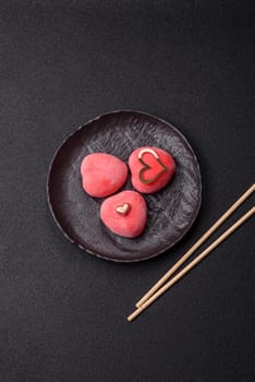 Delicious sweet mochi in the shape of red hearts for the holiday of Valentine's Day