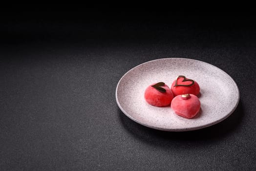 Delicious sweet mochi in the shape of red hearts for the holiday of Valentine's Day
