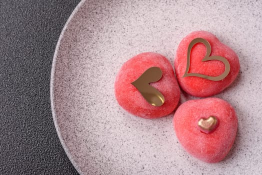 Delicious sweet mochi in the shape of red hearts for the holiday of Valentine's Day