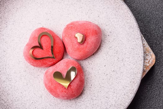 Delicious sweet mochi in the shape of red hearts for the holiday of Valentine's Day