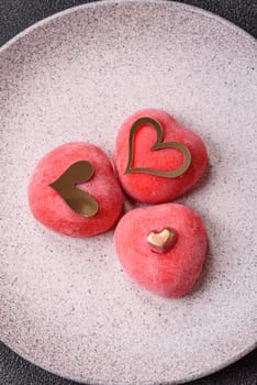 Delicious sweet mochi in the shape of red hearts for the holiday of Valentine's Day