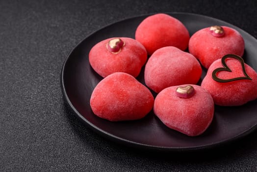 Delicious sweet mochi in the shape of red hearts for the holiday of Valentine's Day