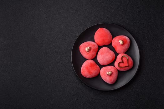 Delicious sweet mochi in the shape of red hearts for the holiday of Valentine's Day