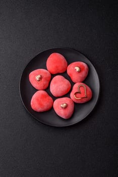 Delicious sweet mochi in the shape of red hearts for the holiday of Valentine's Day