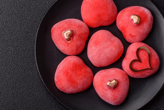 Delicious sweet mochi in the shape of red hearts for the holiday of Valentine's Day