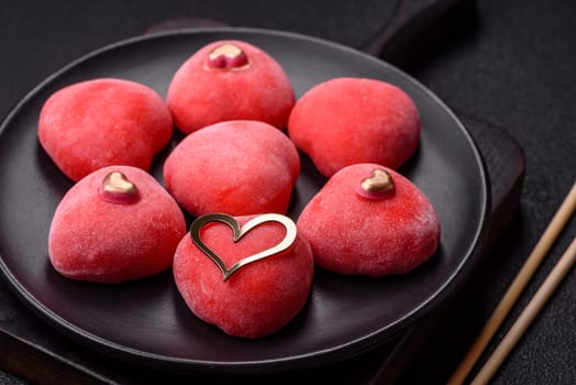 Delicious sweet mochi in the shape of red hearts for the holiday of Valentine's Day
