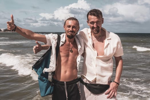 Male tourists men best friends guys are posing for a photo selfie model and having fun swimming on the mexican Caribbean beach in Playa del Carmen Quintana Roo Mexico.