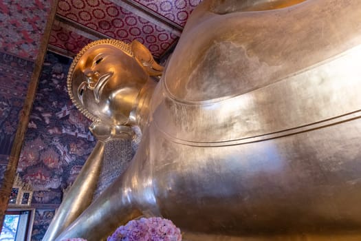 A breathtaking view of the magnificent golden Reclining Buddha at the historic Wat Pho temple in Bangkok