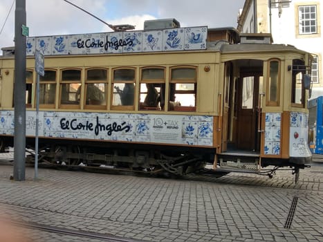 Porto, Europe Portugal -June 7, 2018.yellow tram, residential building with windows . High quality photo