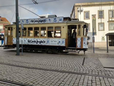 Porto, Europe Portugal -June 7, 2018.yellow tram, residential building with windows . High quality photo