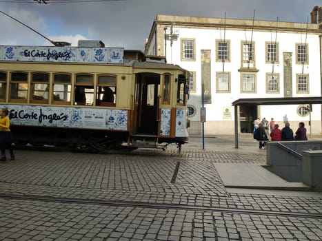 Porto, Europe Portugal -June 7, 2018.yellow tram, residential building with windows . High quality photo
