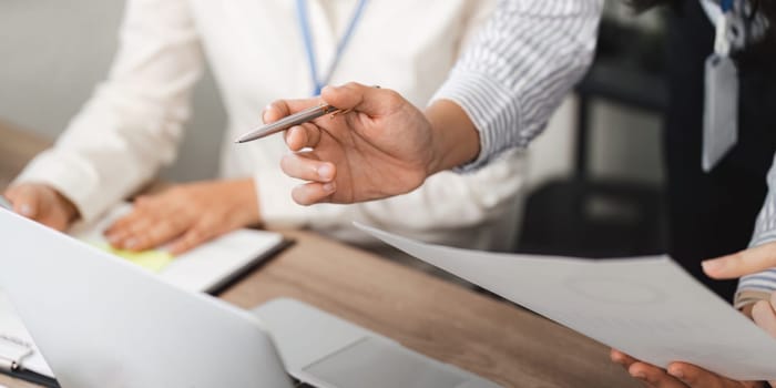 A focused business team engages in document review showcasing teamwork and professionalism in a collaborative office environment.