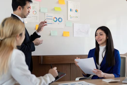 A multicultural business team engaged in a dynamic discussion about financial insights, emphasizing collaboration and effective communication in a contemporary workspace.