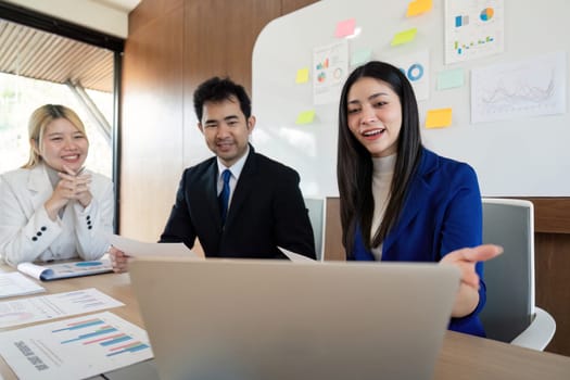 A multicultural business team sharing insights and strategies during a discussion, showcasing collaboration and engagement in a contemporary workspace.
