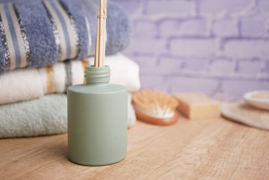 An inviting spa area features a diffuser, towels, and natural decor.