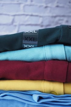 A vibrant pile of XXL clothing showcasing various colors and textures.