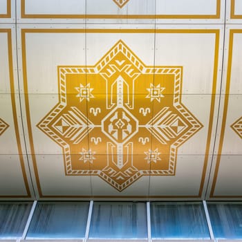 Captivating exterior of Baku Carpet Museum in Azerbaijan, showcasing a striking design inspired by rolled-up carpets. Geometric patterns and golden accents create a stunning architectural statement