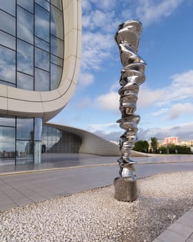 Baku, Azerbaijan - May 7, 2024: Erected before the Hayder Aliyev Center, the sculpture Point of View by artist Tony Cragg stands as a testament to the contemporary design of its surroundings