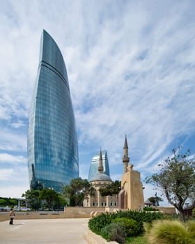 Baku, Azerbaijan - May 6, 2024: The Sehitler Mosque, or Mosque of the Martyrs stands prominently in front of the Flame Towers